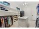 Spacious closet with custom shelving and a stacked washer and dryer at 11064 Hamilton Run, Zionsville, IN 46077