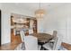 Dining room with round wood table next to an open kitchen at 11064 Hamilton Run, Zionsville, IN 46077