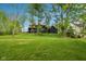 A modern home with dark siding and a large green lawn at 11064 Hamilton Run, Zionsville, IN 46077