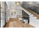 Bright foyer featuring hardwood floors, a statement chandelier, and a staircase with carpeted steps at 11064 Hamilton Run, Zionsville, IN 46077