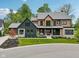 Stunning two-story home featuring a manicured lawn, stylish porch, and a mix of modern black and natural wood accents at 11064 Hamilton Run, Zionsville, IN 46077