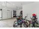 Bright garage with a view to another garage with car, bikes and other storage equipment at 11064 Hamilton Run, Zionsville, IN 46077