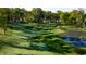 Scenic golf course view featuring lush green grass, sand traps, and a tranquil stream at 11064 Hamilton Run, Zionsville, IN 46077