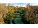 An autumn day on a green golf course surrounded by colorful trees at 11064 Hamilton Run, Zionsville, IN 46077