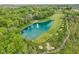 Aerial view of a golf course with a beautiful pond and surrounding greenery at 11064 Hamilton Run, Zionsville, IN 46077