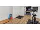 Workout area with wood flooring, exercise bike, pool table and natural light at 11064 Hamilton Run, Zionsville, IN 46077
