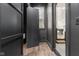 Hallway features dark walls, wood floors, and a glimpse of the staircase and lower level at 11064 Hamilton Run, Zionsville, IN 46077