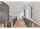 A hallway with wood floors, black framed windows, and wood and iron railing at 11064 Hamilton Run, Zionsville, IN 46077