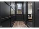 Stylish hallway with dark trim and an open staircase, leading to a game room and other areas of the home at 11064 Hamilton Run, Zionsville, IN 46077