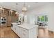 Open kitchen view featuring an island with seating, hardwood floors, and modern fixtures at 11064 Hamilton Run, Zionsville, IN 46077
