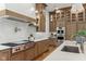 Gourmet kitchen with wood cabinets, stainless steel appliances, and a spacious island with white countertop at 11064 Hamilton Run, Zionsville, IN 46077