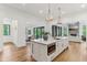 Spacious kitchen island with stainless oven, white countertop, and open layout to the dining and living rooms at 11064 Hamilton Run, Zionsville, IN 46077