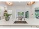 Kitchen island with white countertop, a stainless sink, and view into the dining room at 11064 Hamilton Run, Zionsville, IN 46077