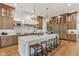 Spacious kitchen with a large island, white countertop, and wooden cabinets at 11064 Hamilton Run, Zionsville, IN 46077