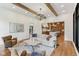 Open-concept living room with hardwood floors, beamed ceilings, and modern finishes at 11064 Hamilton Run, Zionsville, IN 46077