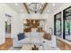 Beautiful living room with a glimpse into the kitchen and a bright window at 11064 Hamilton Run, Zionsville, IN 46077