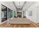 Bright living room with stone fireplace, beamed ceiling, and large windows at 11064 Hamilton Run, Zionsville, IN 46077