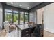 Office features large windows, dark desk and a cozy chair, creating a productive work environment at 11064 Hamilton Run, Zionsville, IN 46077