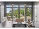 Bright home office with modern desk, decor, and a large window overlooking the landscaped front yard at 11064 Hamilton Run, Zionsville, IN 46077