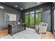 Home office with dark gray walls, dark desk and large window looking out to trees at 11064 Hamilton Run, Zionsville, IN 46077