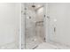 Walk in shower with glass doors and marble tiling at 11064 Hamilton Run, Zionsville, IN 46077