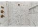 Close up of the marble tiling in a walk in shower with gold fixtures at 11064 Hamilton Run, Zionsville, IN 46077