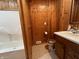 Bathroom featuring wood paneled walls, vanity sink, and a tub shower at 117 Fountain Lake Dr, Greenfield, IN 46140