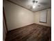 A cozy bedroom featuring dark wood-look floors and a ceiling fan at 117 Fountain Lake Dr, Greenfield, IN 46140