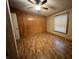 Cozy bedroom with hardwood floors and wood paneling accent wall at 117 Fountain Lake Dr, Greenfield, IN 46140