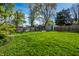 Large grassy backyard featuring a wooden fence and plenty of green space at 1205 N Oxford St, Indianapolis, IN 46201