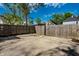 A view of the backyard, featuring a wooden fence and concrete parking area at 1205 N Oxford St, Indianapolis, IN 46201