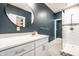 Modern bathroom with new vanity, round mirror, and tiled shower at 1205 N Oxford St, Indianapolis, IN 46201