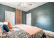 Bedroom featuring a comfortable bed with patterned bedding, exposed brick wall, and windows at 1205 N Oxford St, Indianapolis, IN 46201