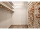 Walk-in closet with shelving and exposed brick accent wall at 1205 N Oxford St, Indianapolis, IN 46201