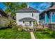 Charming home exterior with a green lawn and a cozy front porch at 1205 N Oxford St, Indianapolis, IN 46201