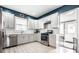 Modern kitchen boasts stainless steel appliances, white cabinets, and ample counter space for cooking at 1205 N Oxford St, Indianapolis, IN 46201