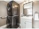Laundry room with stacked washer and dryer unit and modern vanity at 1205 N Oxford St, Indianapolis, IN 46201