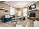 Cozy living room with brick fireplace, plush seating, and modern lighting, creating a welcoming atmosphere at 1205 N Oxford St, Indianapolis, IN 46201