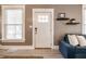 Comfortable living room featuring a modern sofa, elegant shelves, and natural light, creating a cozy ambiance at 1205 N Oxford St, Indianapolis, IN 46201