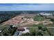 Expansive aerial view showcases new construction development with a mix of open land and industrial buildings at 12613 Morning Ridge Way, Noblesville, IN 46060