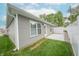 Charming home with a lush green yard, white fence, and a patio area perfect for outdoor entertainment at 1491 Coen Ct, Columbus, IN 47201