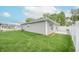 Spacious backyard featuring modern exterior, manicured lawn, and a privacy fence at 1491 Coen Ct, Columbus, IN 47201