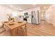 Bright eat-in kitchen featuring stainless steel appliances, sleek white cabinetry, and a dining table at 1491 Coen Ct, Columbus, IN 47201