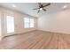 Bright and airy space with wood-look floors, a ceiling fan, and access to the outdoors at 1491 Coen Ct, Columbus, IN 47201