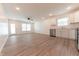 Bright, open living space with wood floors, white walls, and a modern kitchen setup in the background at 1491 Coen Ct, Columbus, IN 47201