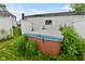 Backyard area with a hot tub and white fence, with plenty of plant life at 1507 N Luett Ave, Indianapolis, IN 46222