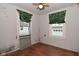 Bedroom featuring hardwood floors, two windows and colorful window coverings at 1507 N Luett Ave, Indianapolis, IN 46222