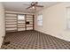 Bedroom featuring a ceiling fan, large windows and built-in shelving at 1507 N Luett Ave, Indianapolis, IN 46222
