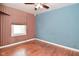 Bedroom featuring a colorful accent wall, window and hardwood floors at 1507 N Luett Ave, Indianapolis, IN 46222