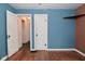 Bedroom featuring hardwood floors, colorful wallpaper and a connecting door at 1507 N Luett Ave, Indianapolis, IN 46222